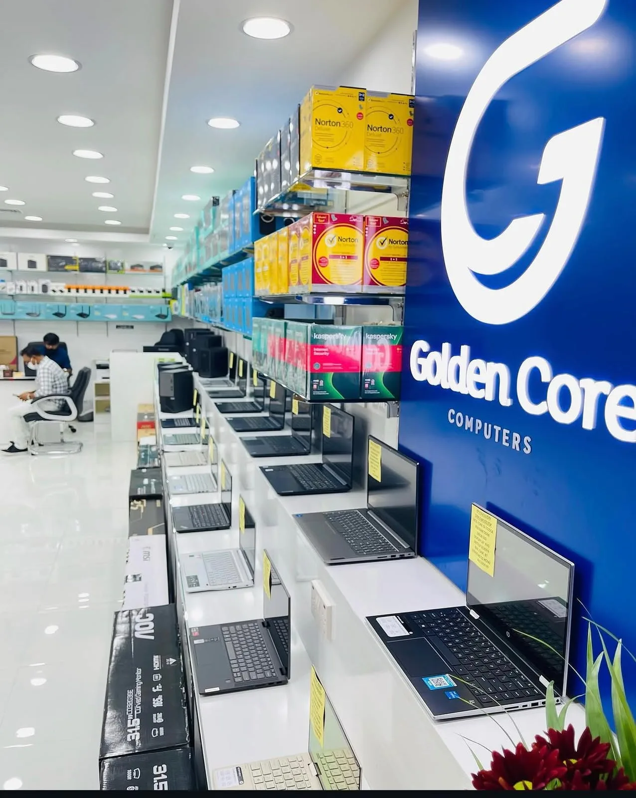 Laptops display wall at Golden Core Computers — HP and branded laptops with networking products